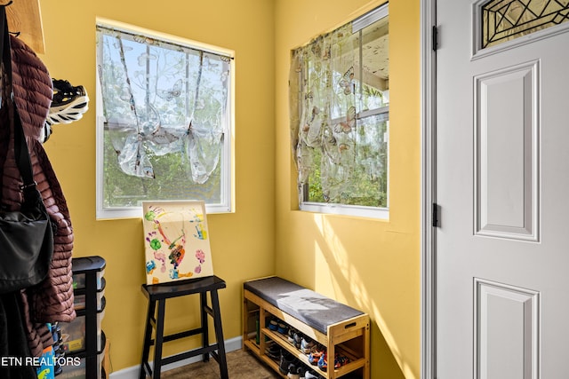 doorway featuring baseboards