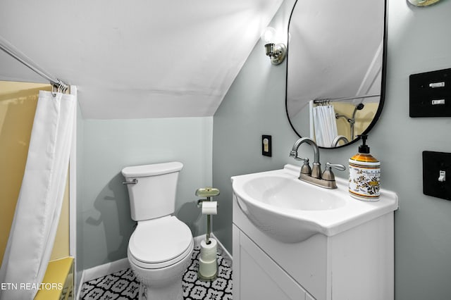 full bathroom with toilet, baseboards, lofted ceiling, and vanity