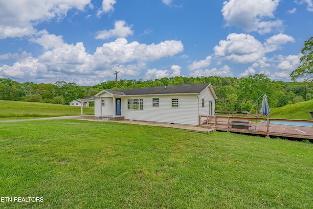 view of front of home featuring a deck and a front yard