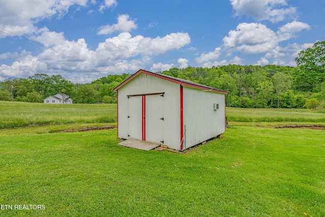 view of shed with a forest view