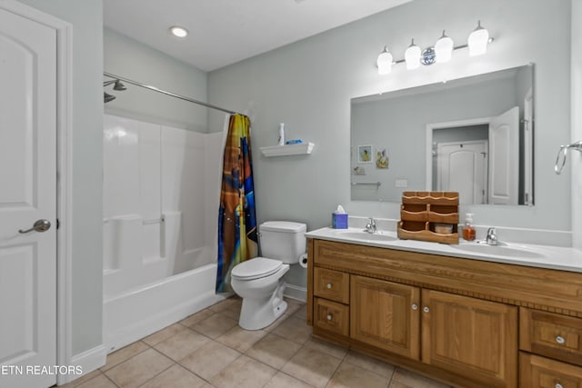 bathroom featuring double vanity, tile patterned flooring, shower / bath combo, a sink, and toilet