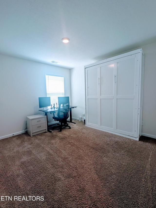 office featuring carpet flooring, baseboards, and visible vents