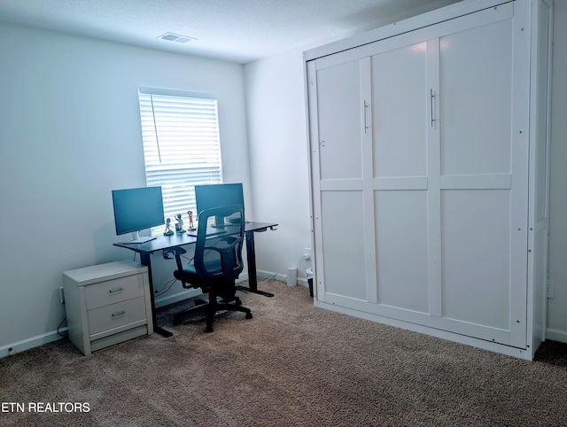 office space with carpet, visible vents, and baseboards