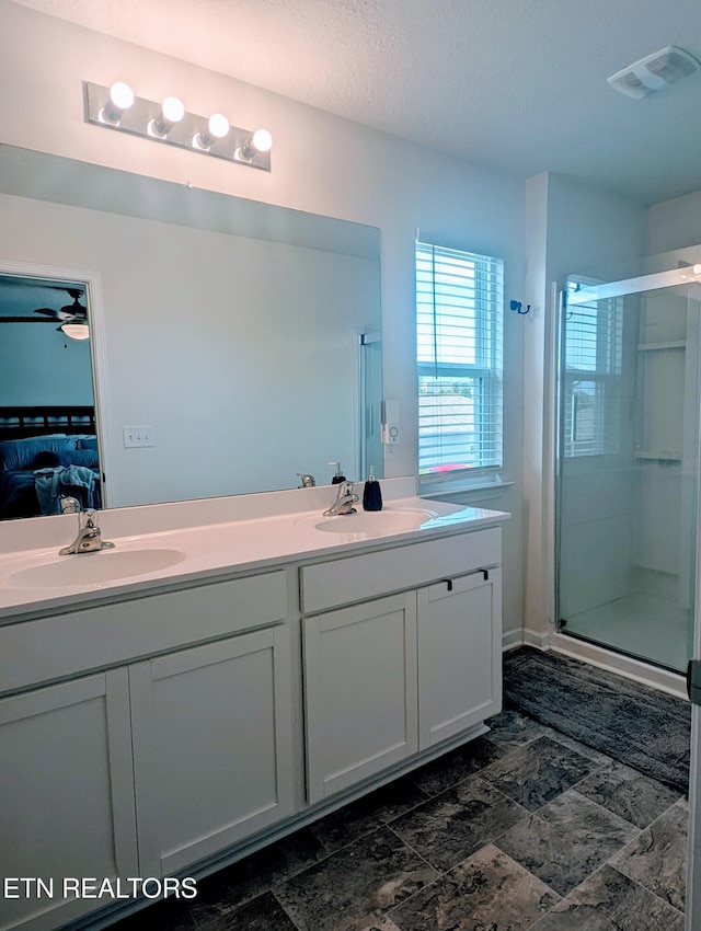 bathroom featuring a stall shower, ensuite bath, visible vents, and a sink