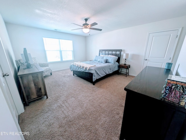 bedroom featuring carpet flooring, baseboards, a ceiling fan, and visible vents