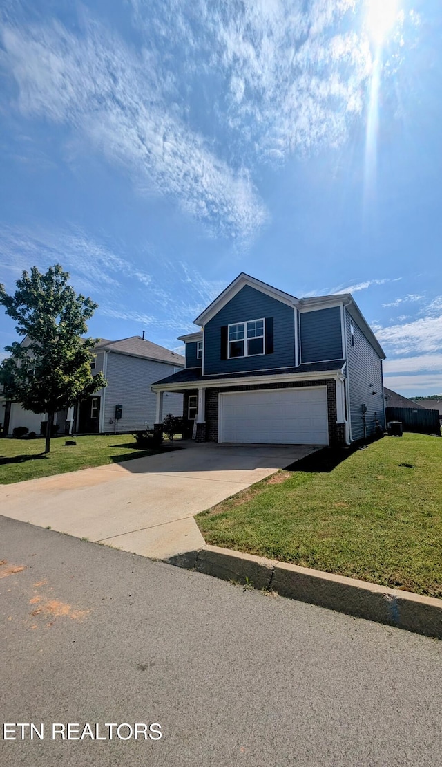 traditional home featuring concrete driveway, an attached garage, brick siding, and a front yard