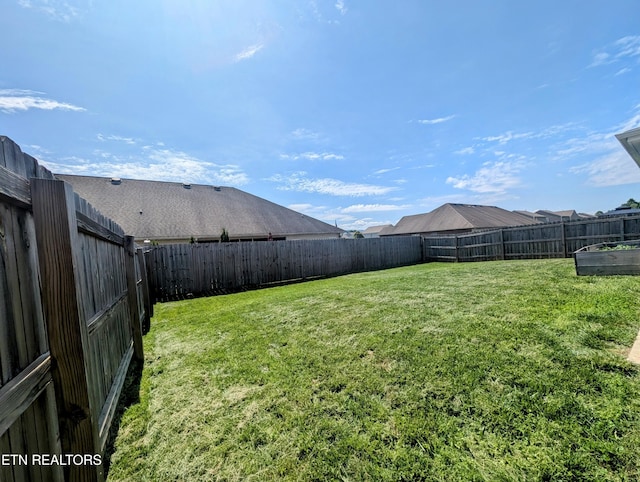 view of yard with a fenced backyard