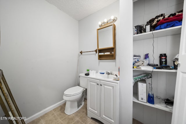 301 Hill St, Rocky Top, TN 37769 - half bath featuring baseboards, toilet, a textured ceiling, and vanity