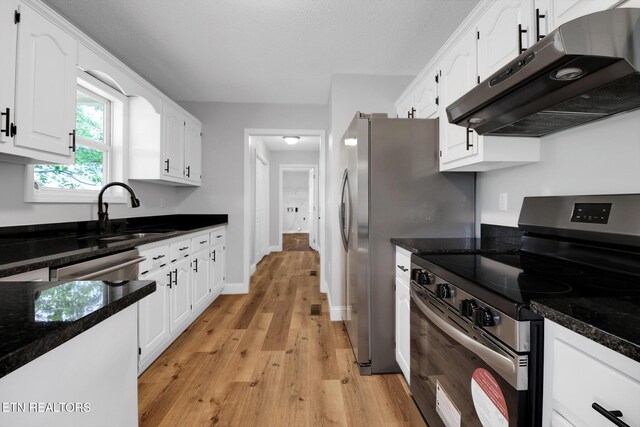 1228 Allardt Hwy, Jamestown, TN 38556 - kitchen featuring stainless steel electric range oven, under cabinet range hood, white cabinetry, a sink, and light wood-style floors