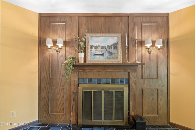 details featuring baseboards and a tiled fireplace