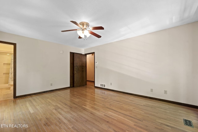 unfurnished room featuring light wood-style floors, baseboards, a ceiling fan, and visible vents