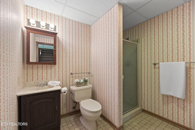 full bath with toilet, a shower stall, a paneled ceiling, and tile patterned flooring