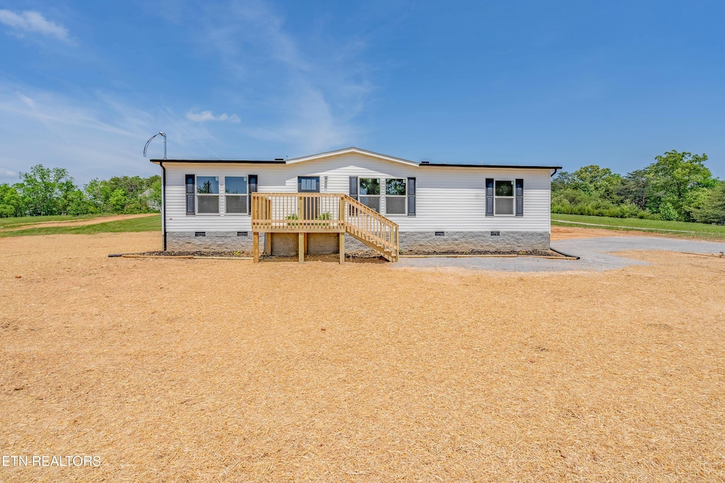 manufactured / mobile home featuring stairs, crawl space, and a deck