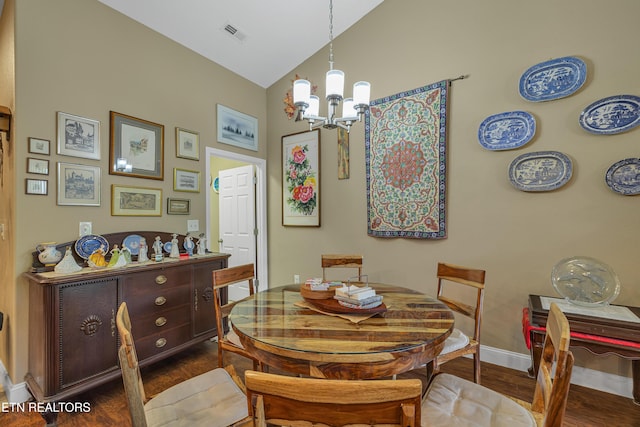 dining area with visible vents, wood finished floors, baseboards, high vaulted ceiling, and an inviting chandelier