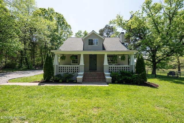 5729 Brown Gap Rd, Knoxville, TN 37918 - view of front facade with a porch, roof with shingles, fence, a front yard, and a chimney