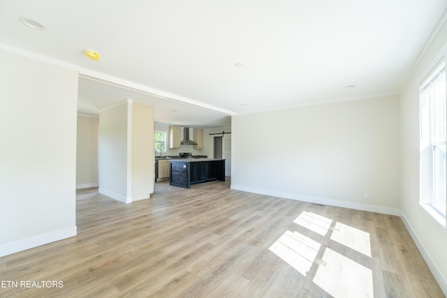 2128 Duncan Rd, Maryville, TN 37803 - unfurnished living room with healthy amount of natural light, light wood-style floors, baseboards, and a barn door