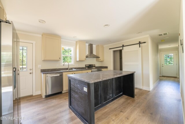2128 Duncan Rd, Maryville, TN 37803 - kitchen with appliances with stainless steel finishes, a barn door, wall chimney range hood, a kitchen island, and a sink