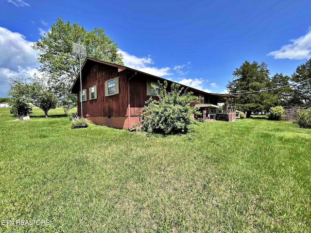 view of property exterior with a lawn and crawl space