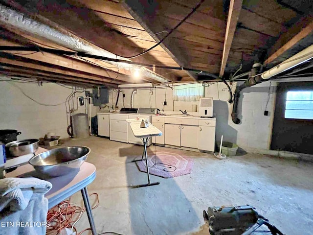 below grade area featuring washing machine and clothes dryer