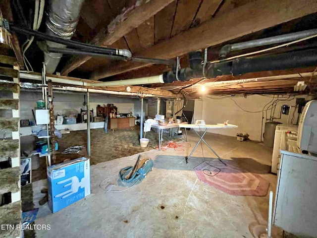 unfinished below grade area featuring washer / dryer