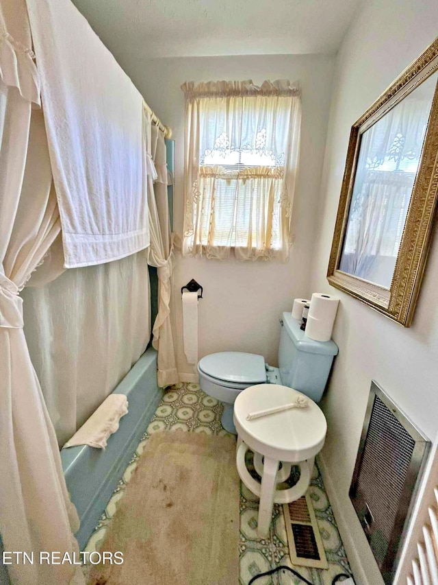 bathroom with baseboards, visible vents, toilet, and plenty of natural light