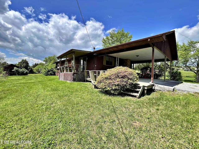 exterior space with a lawn and a carport