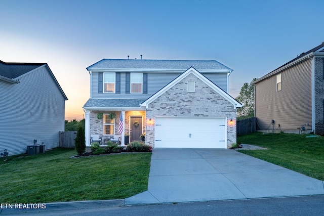 7849 Beeler Farms Ln, Knoxville, TN 37918 - traditional home featuring a porch, a yard, concrete driveway, and a garage