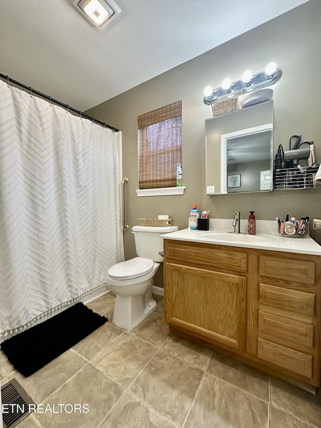 bathroom with toilet, tile patterned floors, visible vents, and vanity