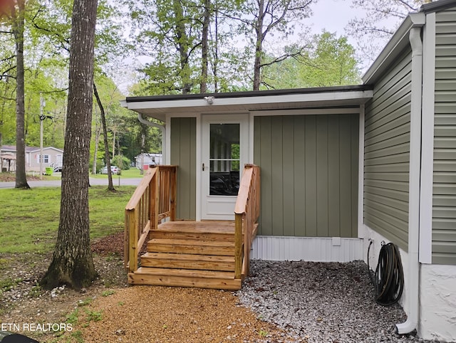 entrance to property with a lawn