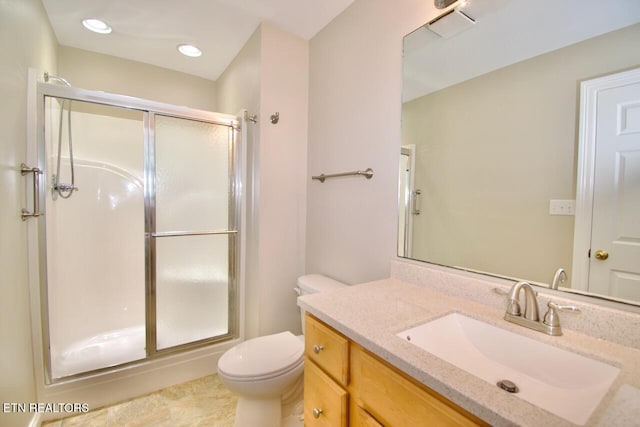 bathroom featuring toilet, recessed lighting, a shower stall, and vanity