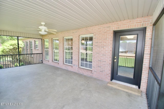 unfurnished sunroom with a ceiling fan and a wealth of natural light