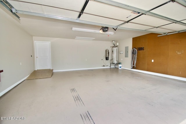 garage with baseboards, a garage door opener, and water heater