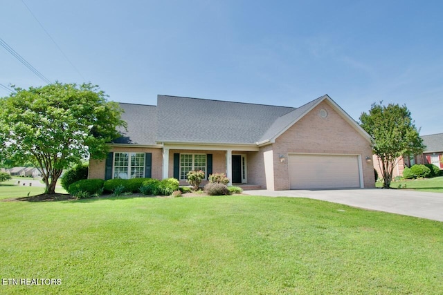 single story home featuring brick siding, a garage, a front lawn, and driveway