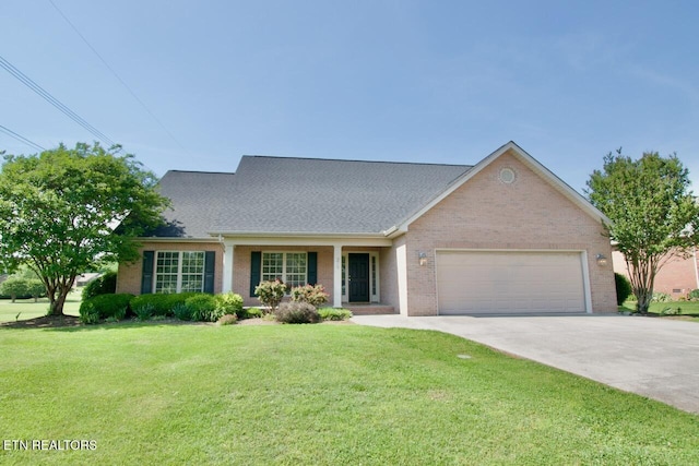 view of front of house with brick siding, a garage, a front lawn, and driveway