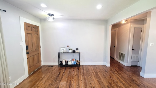 entrance foyer with baseboards, wood finished floors, and visible vents