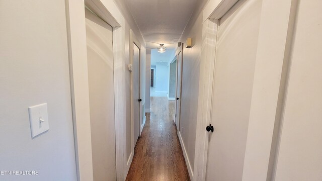 corridor featuring dark wood-type flooring
