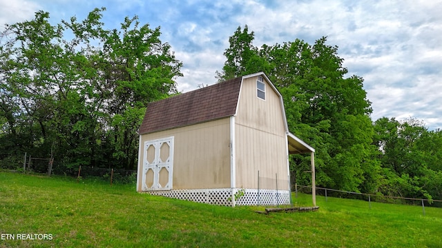 view of outbuilding featuring fence and an outdoor structure