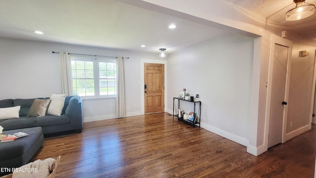 living room featuring recessed lighting, baseboards, and wood finished floors