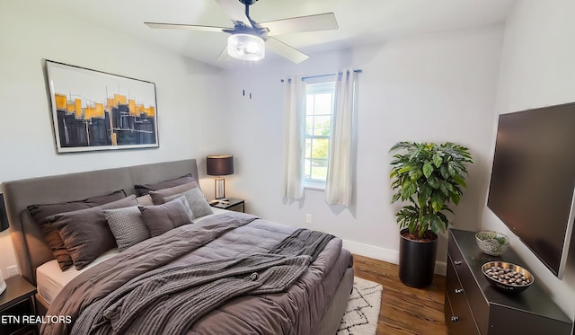 bedroom featuring baseboards, ceiling fan, and wood finished floors