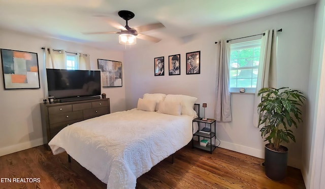 bedroom with baseboards, dark wood-style flooring, and ceiling fan
