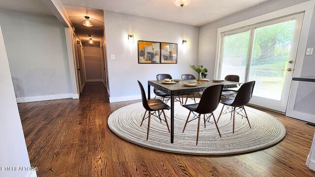 dining room featuring baseboards and wood finished floors