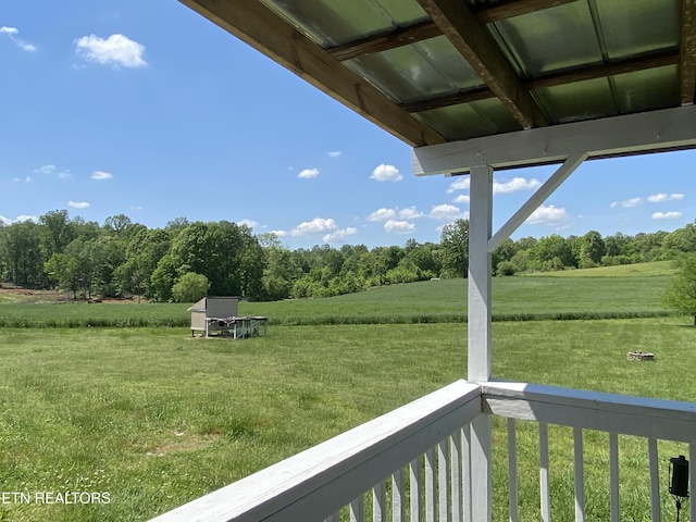 exterior space with a rural view and a balcony