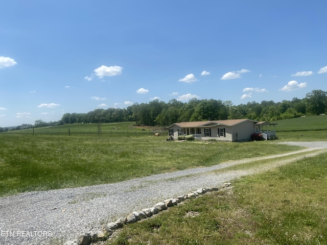 view of road featuring a rural view and driveway