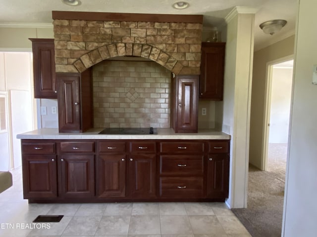 kitchen with tasteful backsplash, dark brown cabinets, ornamental molding, and black electric stovetop