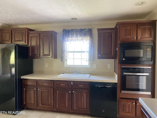 kitchen with light countertops, black appliances, ornamental molding, a sink, and a textured ceiling