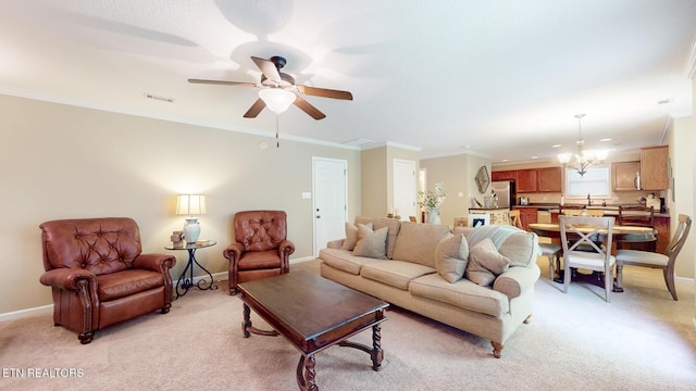 living area with baseboards, ceiling fan with notable chandelier, light colored carpet, and visible vents