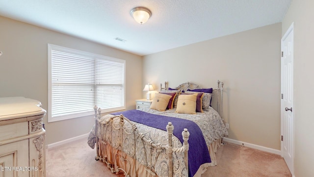 bedroom with light colored carpet, baseboards, and visible vents