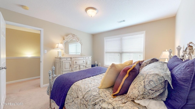 bedroom featuring baseboards, visible vents, and carpet