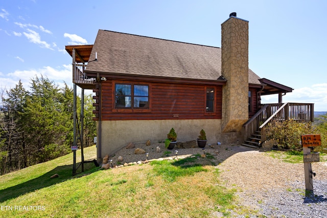 936 Buck Way, Sevierville, TN 37876 - exterior space with a chimney, roof with shingles, a front yard, and log exterior