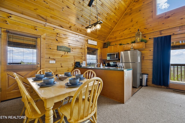 936 Buck Way, Sevierville, TN 37876 - dining space with wood ceiling, a skylight, wood walls, high vaulted ceiling, and light carpet